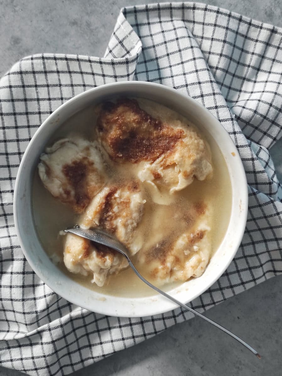 Zagorski Štrukli Served in Soup (Croatian Cheese Dumpling Soup) with a spoon