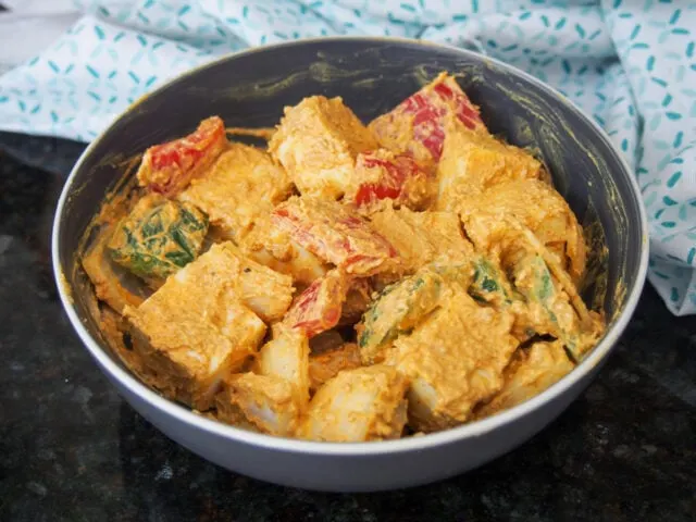 Marinating the cheese and vegetables for Paneer Tikka 
