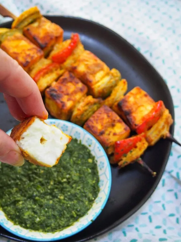 Indian Paneer Tikka appetizer - a bite taken out of a piece of the cheese