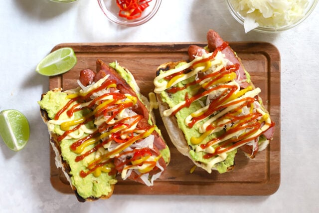 Guatemalan Shucos Hot Dogs with guacamole and a toasted bun