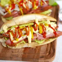 Guatemalan Shucos Hot Dogs with guacamole and sausage crop