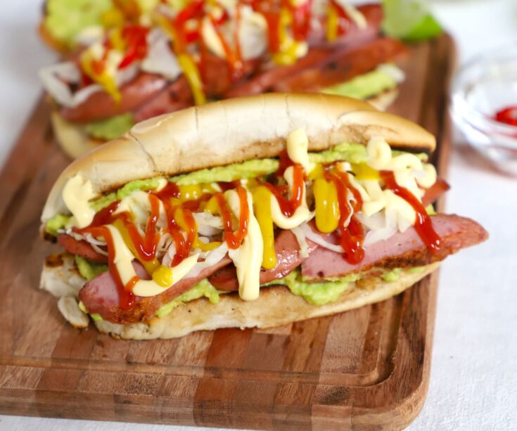 Guatemalan Shucos Hot Dogs with guacamole and sausage crop
