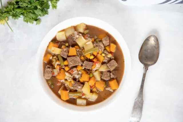 Chilean Carbonada beef soup with potatoes and squash