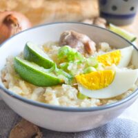 Chicken Arroz Caldo Filipino Rice Porridge with lime and hard boiled eggs