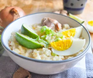 Chicken Arroz Caldo Filipino Rice Porridge with lime and hard boiled eggs