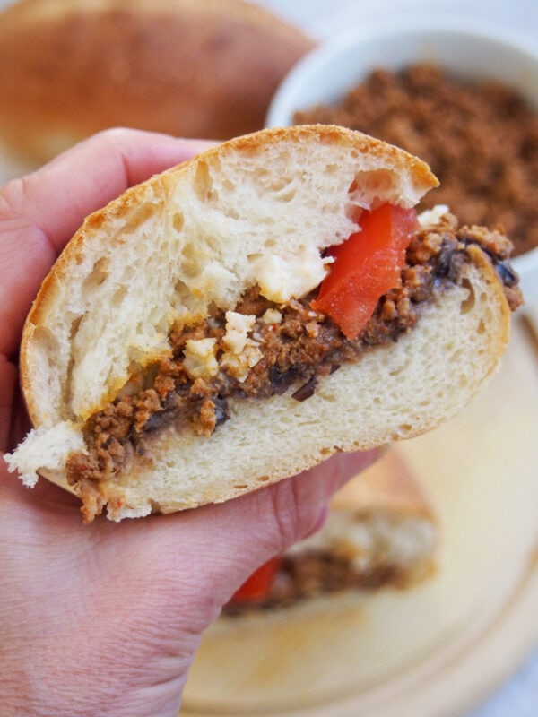 Chorizo torta in a hand - Eating a Mexican chorizo sandwich