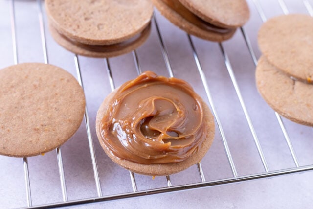 Adding the dulce de leche filling for Alfajores Marplatenses - Chocolate alfajores