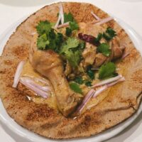 Padampuri Murgh (Padampuri chicken curry) on Indian flatbread