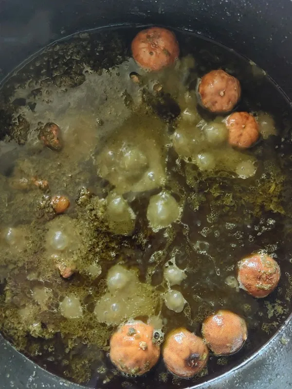 Adding dried limes to Iranian herb stew