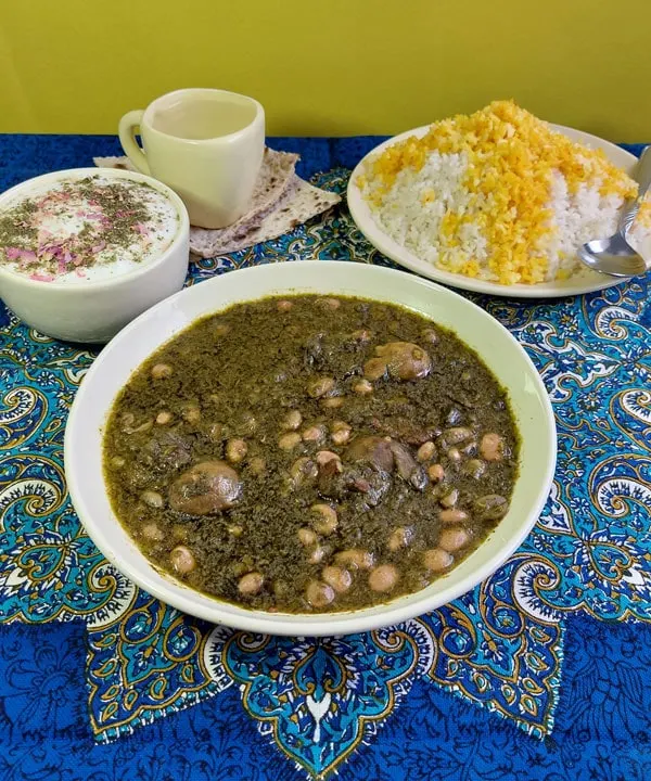 Iranian Khoresht sabzi - herb stew served with rice and doogh