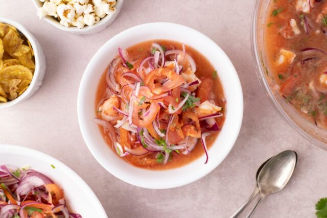 Ecuadorian cooked shrimp ceviche - shrimp soup with tomato and lime, served with popcorn 