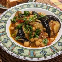 Manzaleh (Middle Eastern Chickpea Eggplant Stew) served with challah bread cropped
