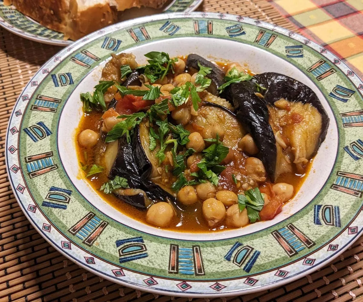 Manzaleh (Middle Eastern Chickpea Eggplant Stew) served with challah bread cropped