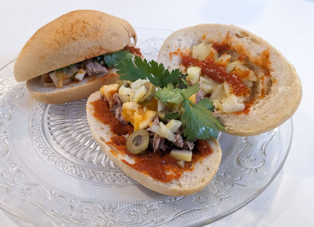 A Tunisian Fricassé street food sandwich - spicy tuna sandwich with eggs and potatoes on a baguette