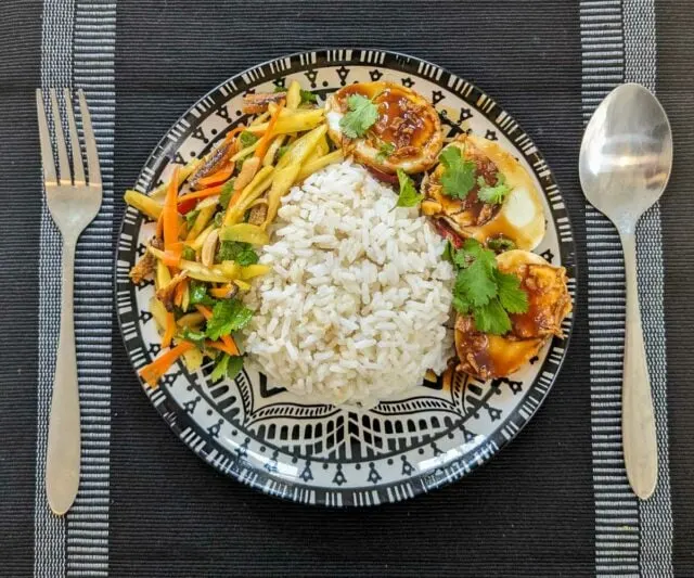 Thai mango salad - yum mamuang with rice and son-in-law's eggs - traditional Thai meal