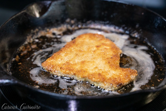 Frying breaded pork for Schweineschnitzel (German Pork Schnitzel)